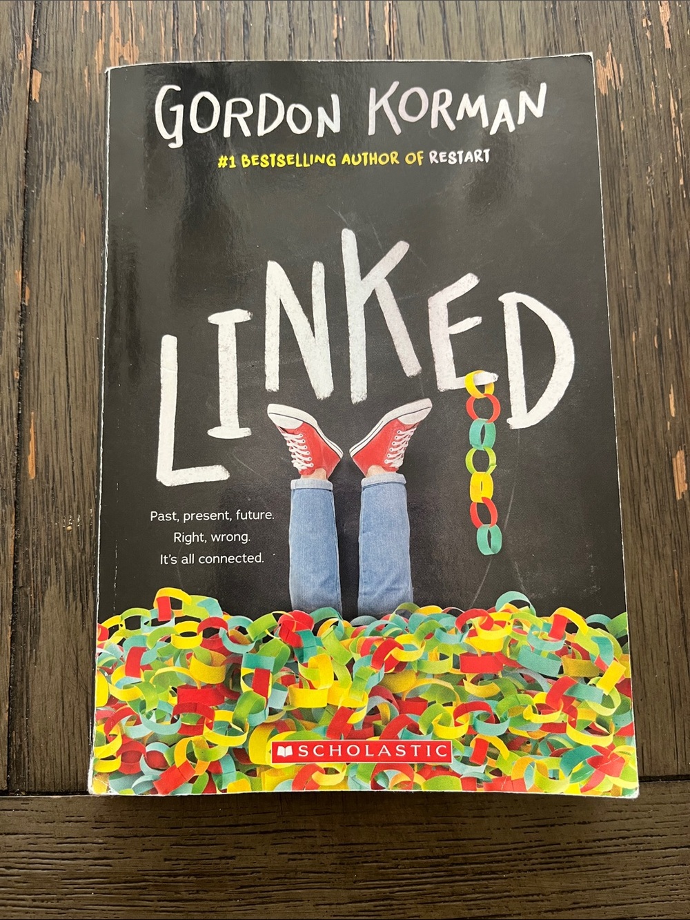 Scholastic Paperback with Black Background and Red Sneakers